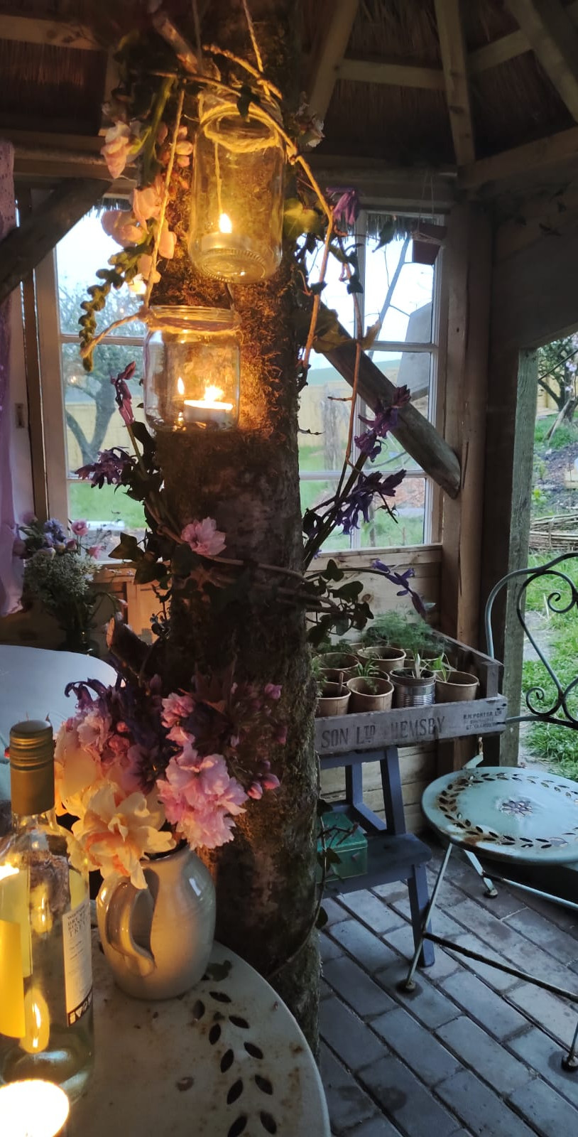 Cozy gazebo decorated with lanterns and flowers
