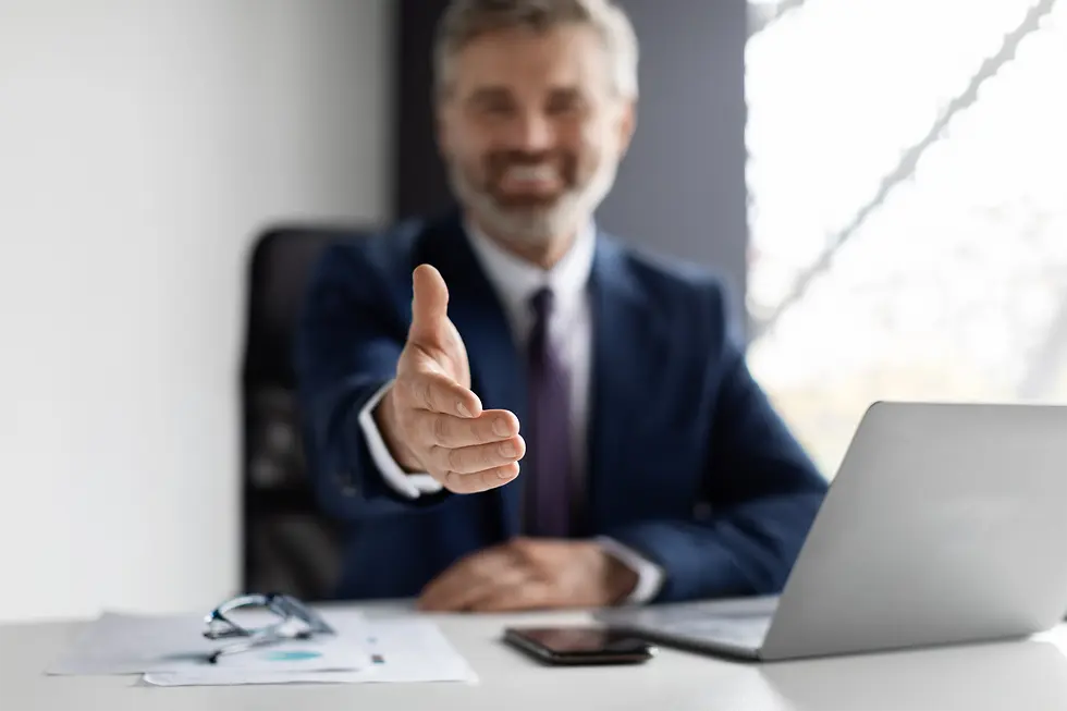 A man extending out his hand to shake.