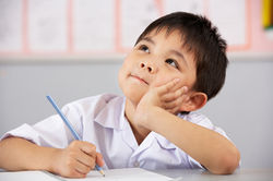 Male Student Working At Desk In Chinese