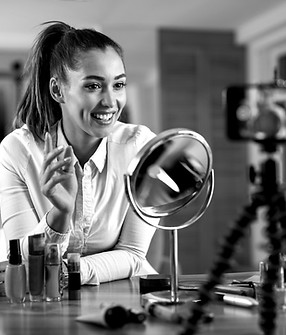 smiling-female-influencer-talking-about-beauty-products-while-vlogging-from-home_edited.jp