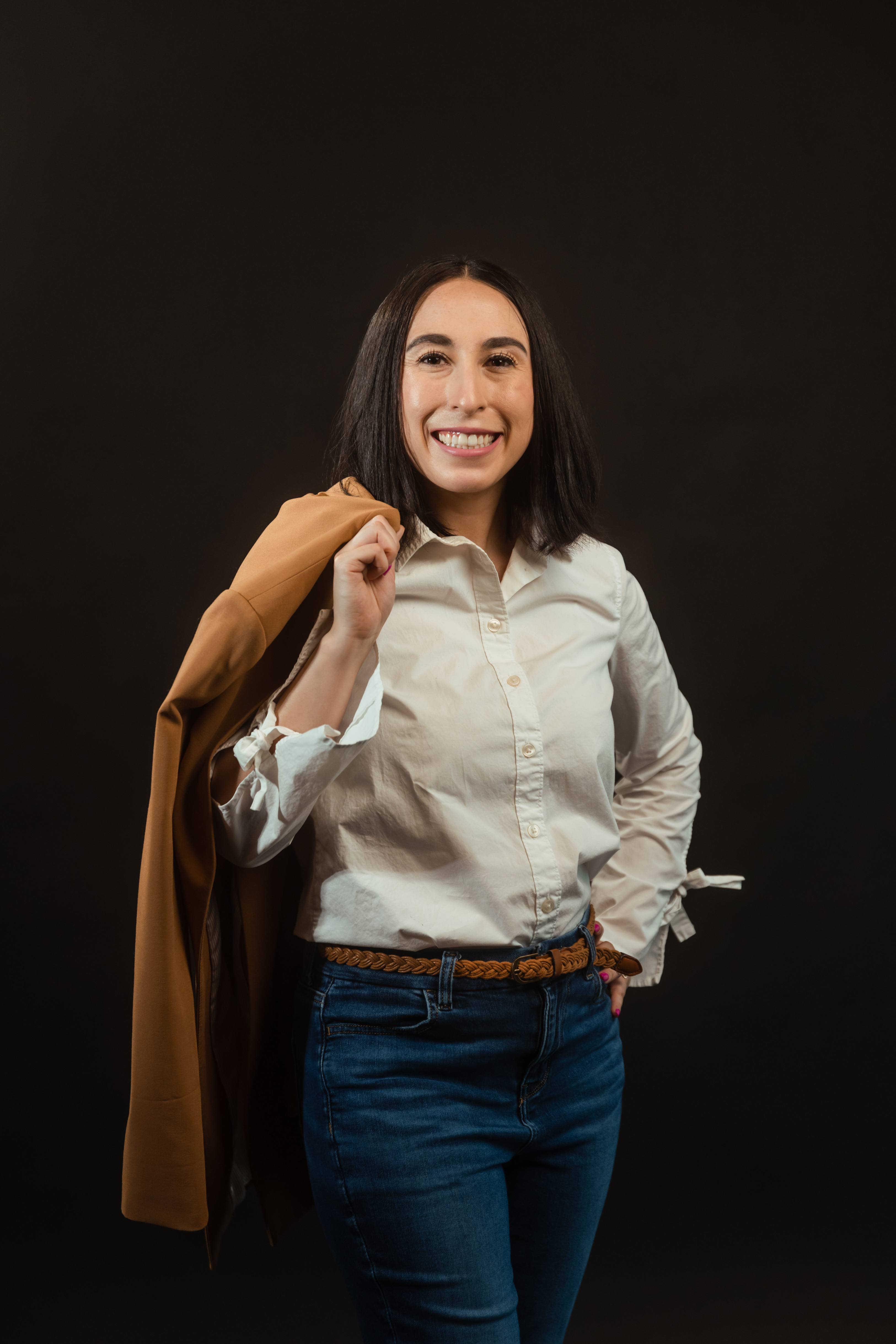 professional headshot of a woman against a black background