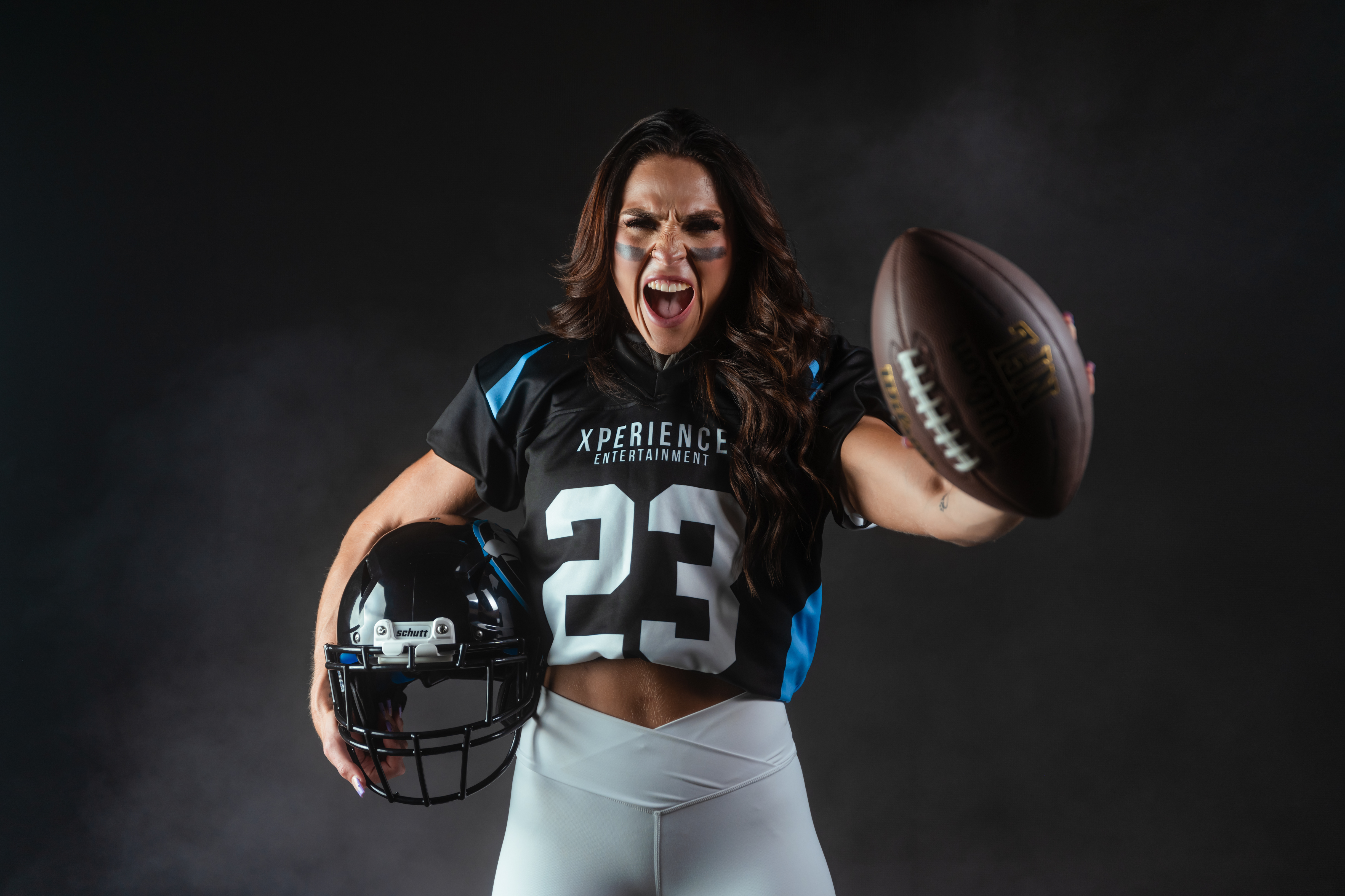 promotional photo of a woman in American football gear