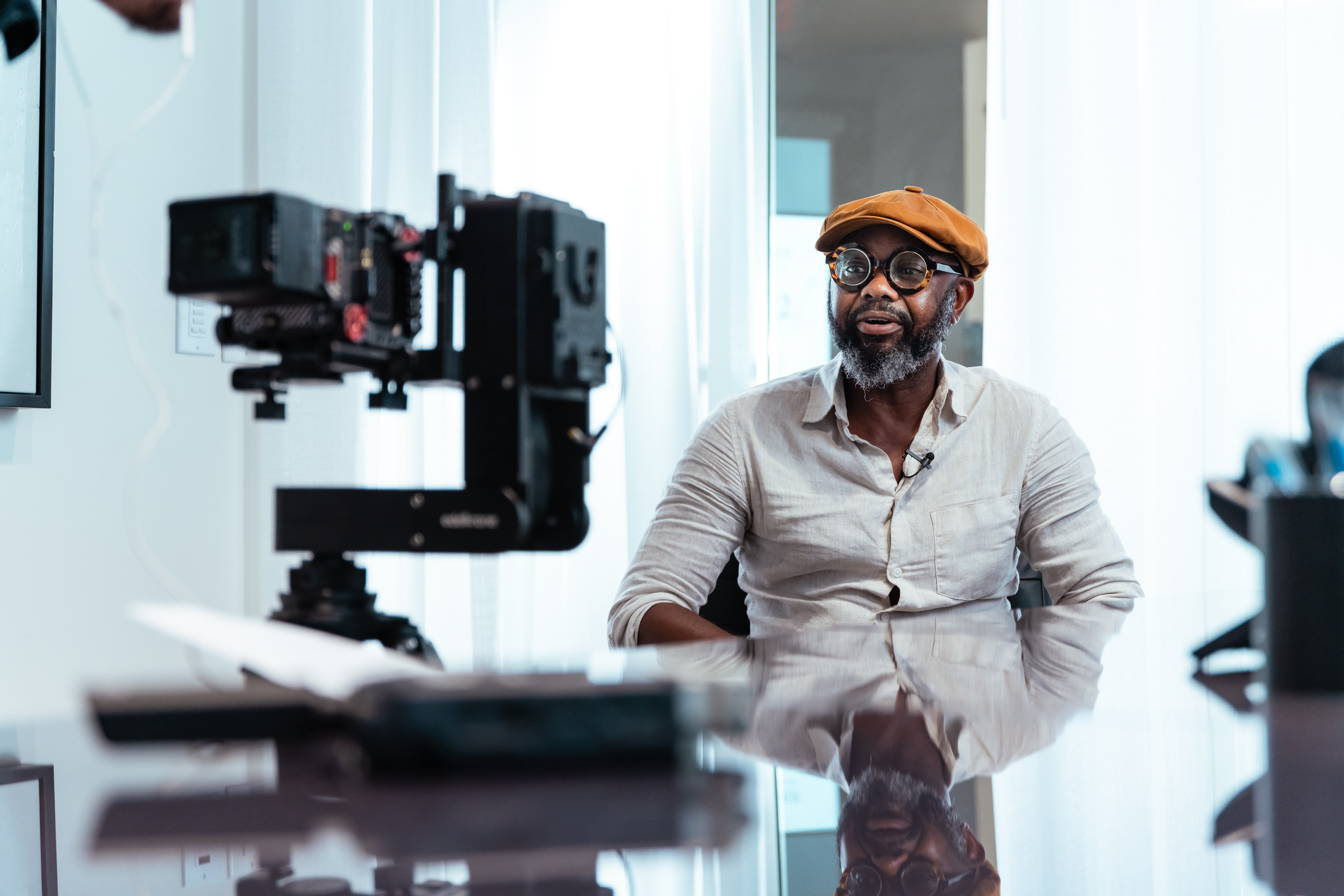 Client smiling as they prepare for testimonial for AZ Accident, Red Komodo camera and Aputure lighting gear in frame.
