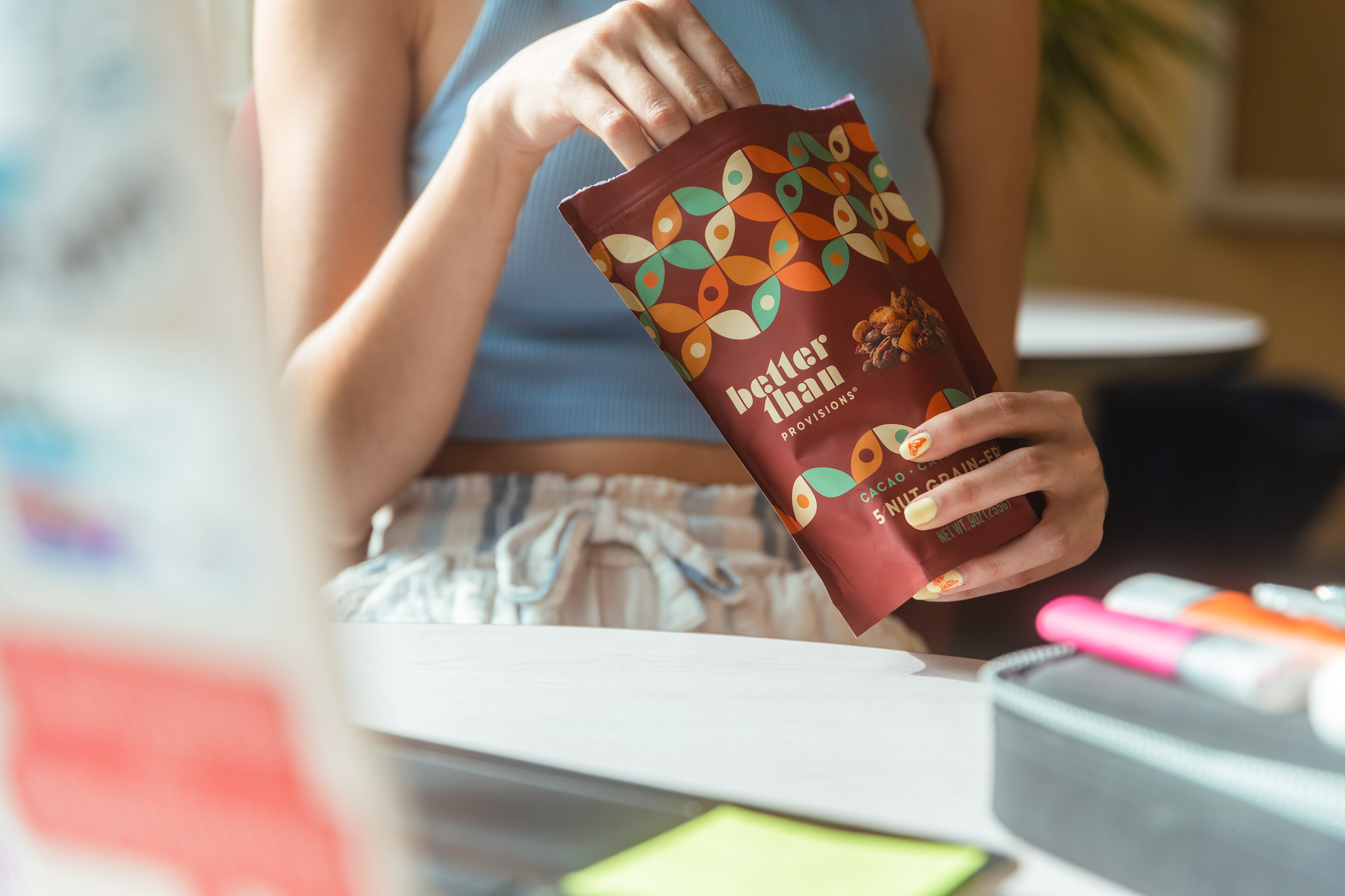 Student enjoying Better Than Provisions granola while studying in school environment.
