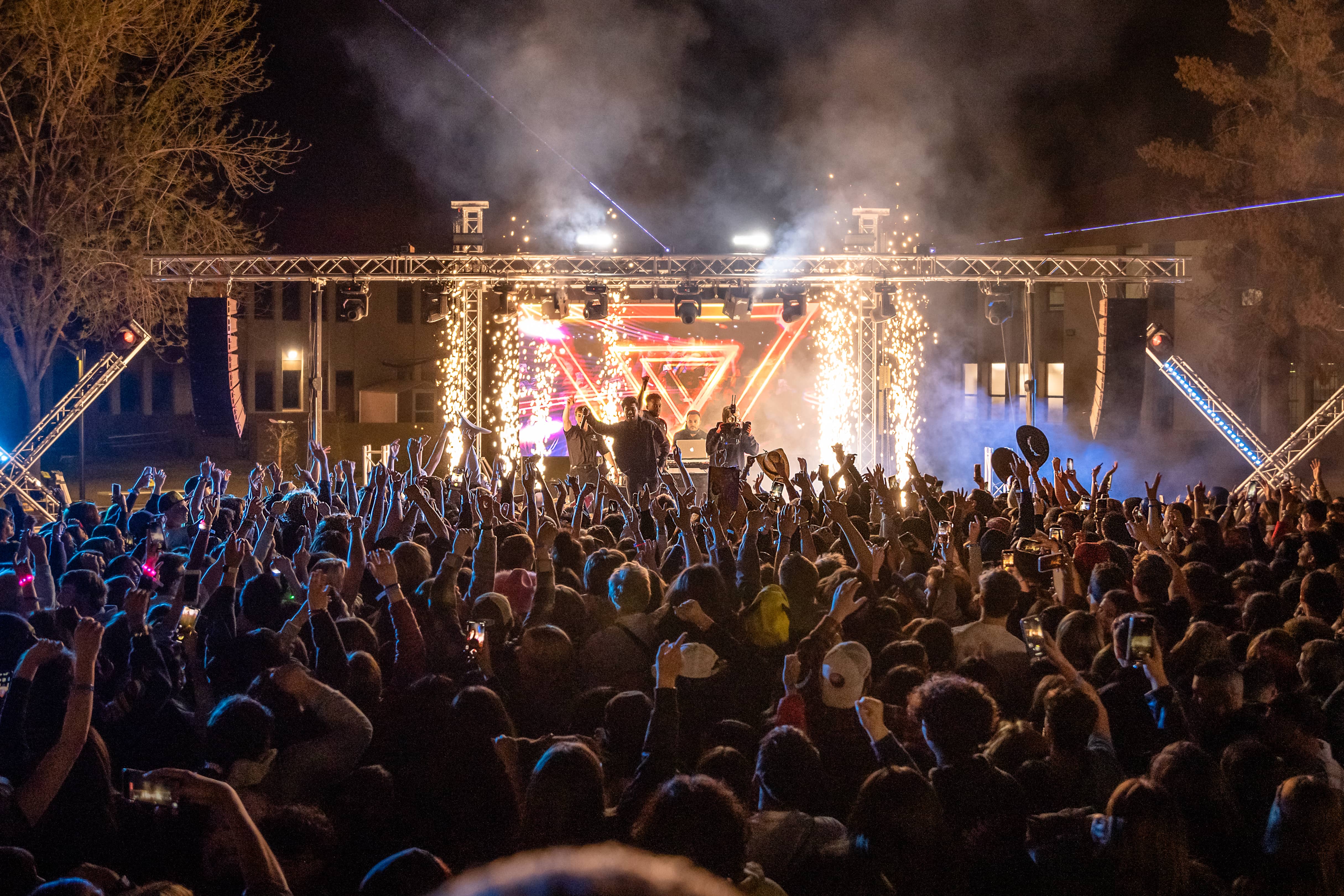 Wide shot of Xperience Entertainment DJs on stage at AASC Conference with crowd, trussing, lighting, and LED video wall.
