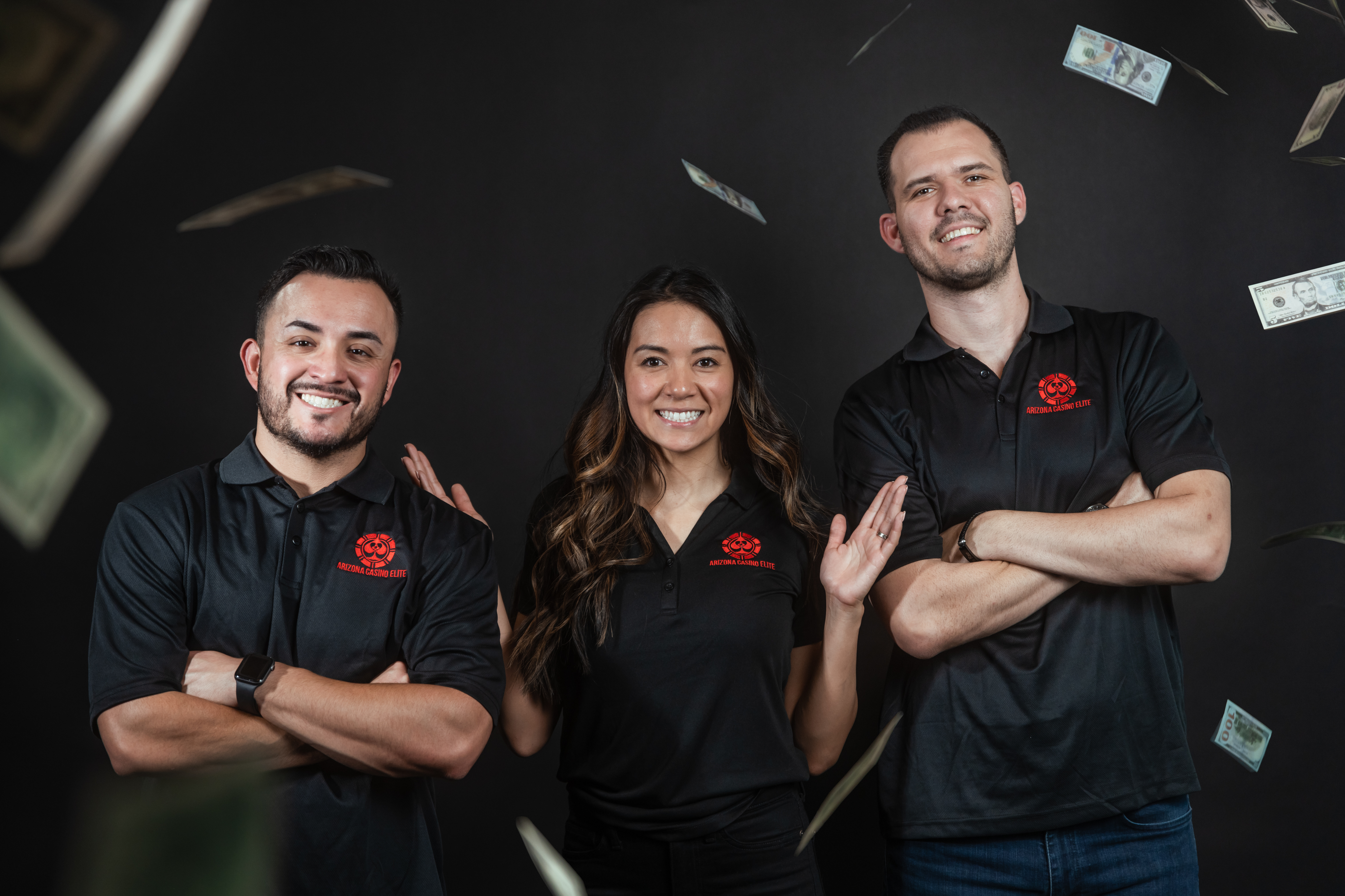 professional team portrait of three people against a black background with dollar bills adorning the frame and composition