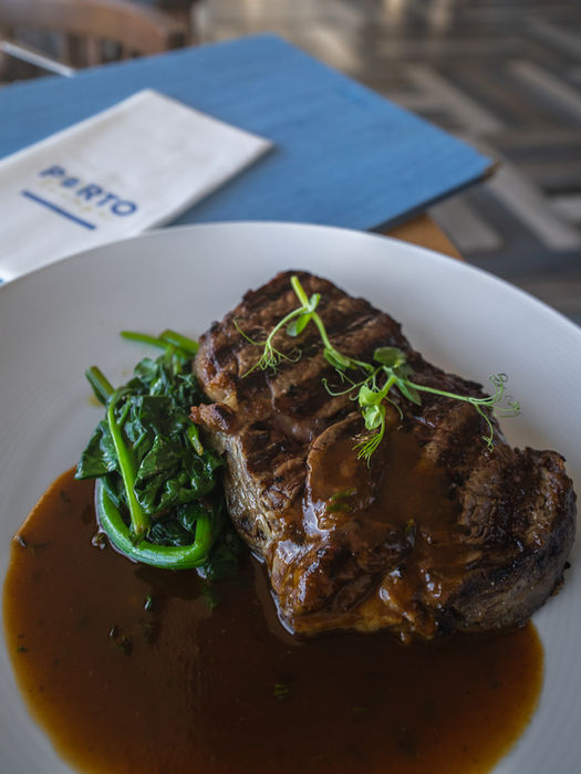 Braised beef dish with fresh greens in savory brown sauce.