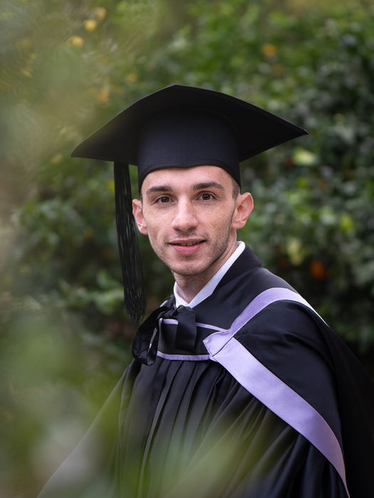 graduation photo of a man boy in his academic regalia