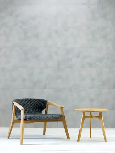 KNIT outdoor lounge armchair in teak and woven rope in an outdoor setting