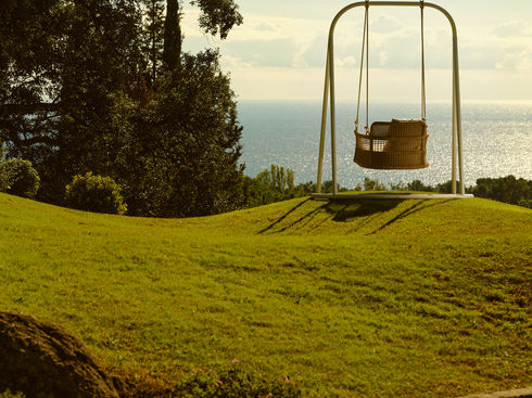 ESCALA outdoor swing set against an ocean view