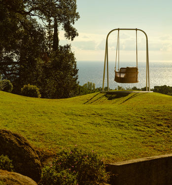 ESCALA outdoor swing set against an ocean view