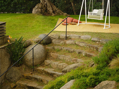 ESCALA Swing with base beside stone garden steps