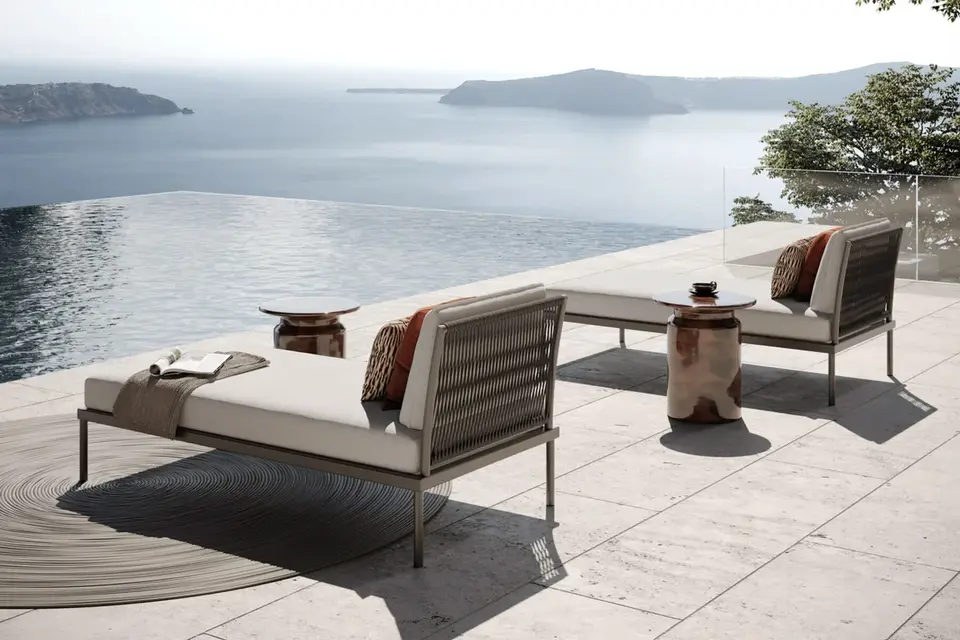 Daybed outdoor furniture from the FLASH Collection overlooking a coastal view.