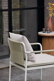 Detail of AIR Armchair frame and cushion against architectural backdrop