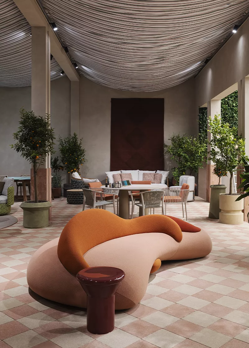 Ethimo Milan Design Week installation with sculptural seating, patterned flooring and planting in a refined outdoor setting.