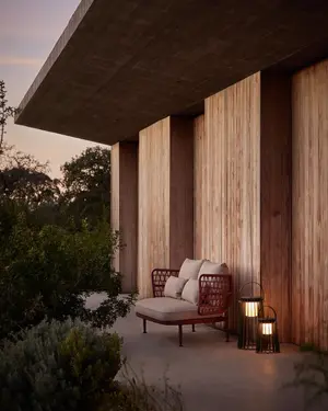 CURIO 2-Seater Sofa featured in a minimalist outdoor seating arrangeent.
