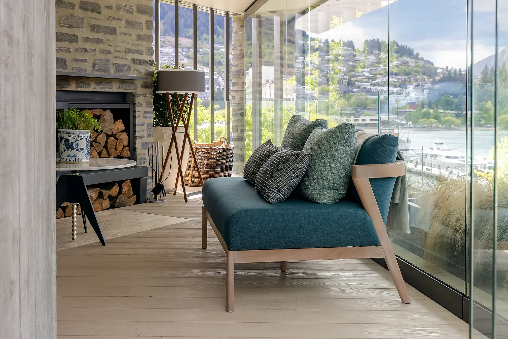 Coco Wolf Porto sofa beside a stone fireplace at ROKI Collection Queenstown