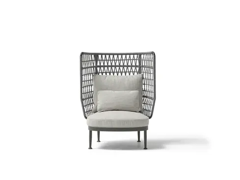 Wide studio shot of the CURIO Armchair with braided rope backrest and plush cushions.