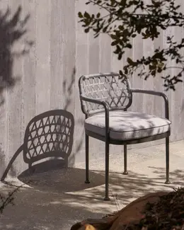 CURIO Dining Chair positioned on a stylish outdoor deck.