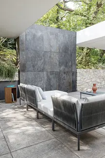 Side view of FLASH modular outdoor sofa showcasing hand-woven rope design