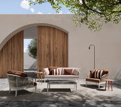 DREAM outdoor armchair featuring a curved rope‑woven backrest, durable aluminium structure, and weather‑resistant cushions.