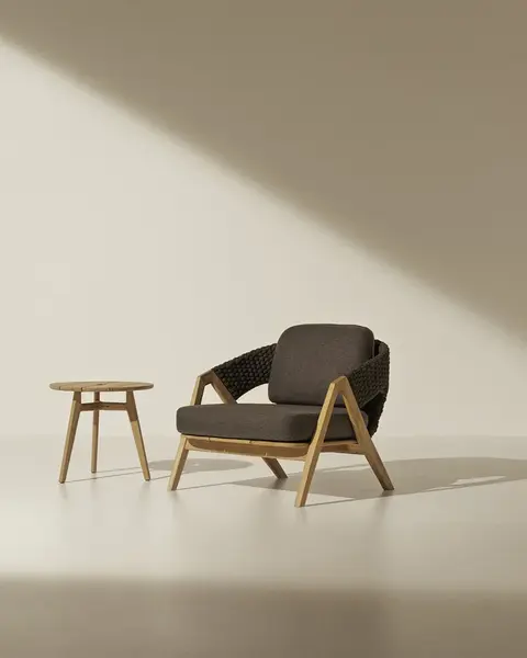 KNIT outdoor armchair in teak and woven rope in an outdoor setting