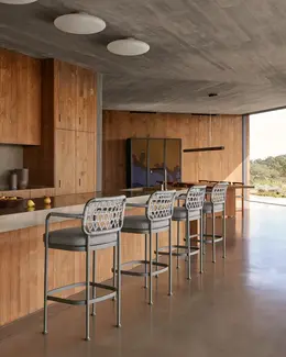 CURIO Bar Stools placed by kitchen, blending with contemporary decor.