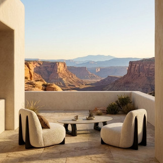 Two Coco Wolf Paloma lounge chairs with rounded cream upholstery and dark sculptural frames on a framed outdoor terrace.