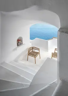 KILT outdoor dining armchair in teak, styled around an outdoor dining table