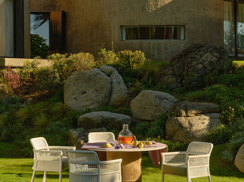 White ESCALA Dining Armchairs around a garden dining table
