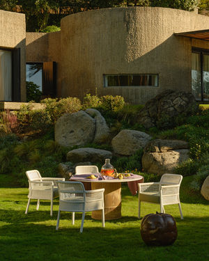 White ESCALA Dining Armchairs around a garden dining table