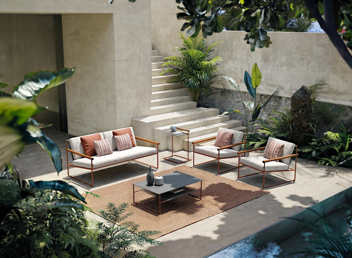 Outdoor rug anchoring a Pipe Collection seating area, adding warmth and defining the space.