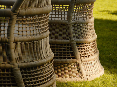 Woven backrest detail of the ESCALA Lounge Chair in natural linen