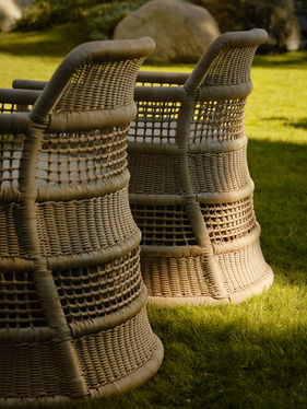Woven backrest detail of the ESCALA Lounge Chair in natural linen