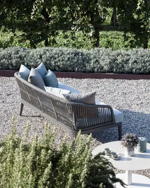 DREAM outdoor sofa with hand‑woven rope backrest, powder‑coated aluminium frame, and plush quick‑dry cushions.
