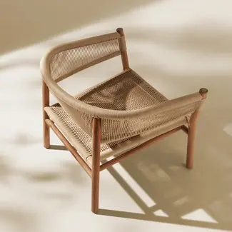 KILT outdoor lounge armchair in teak, styled in an outdoor living space