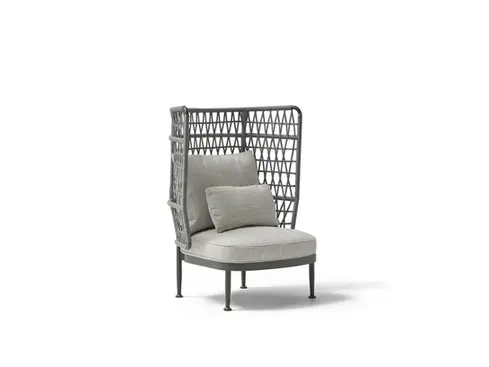 Wide studio shot of the CURIO Armchair with braided rope backrest and plush cushions.