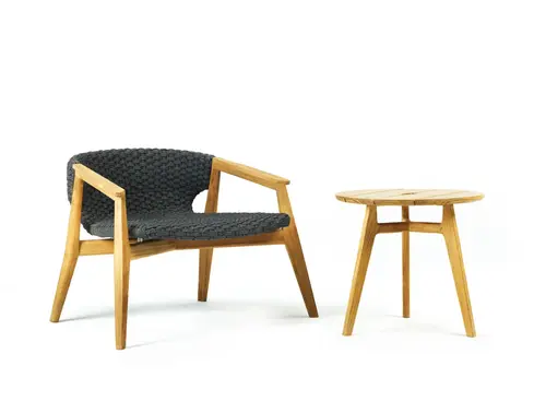 KNIT outdoor lounge armchair and side table in teak and woven rope photographed in studio setting
