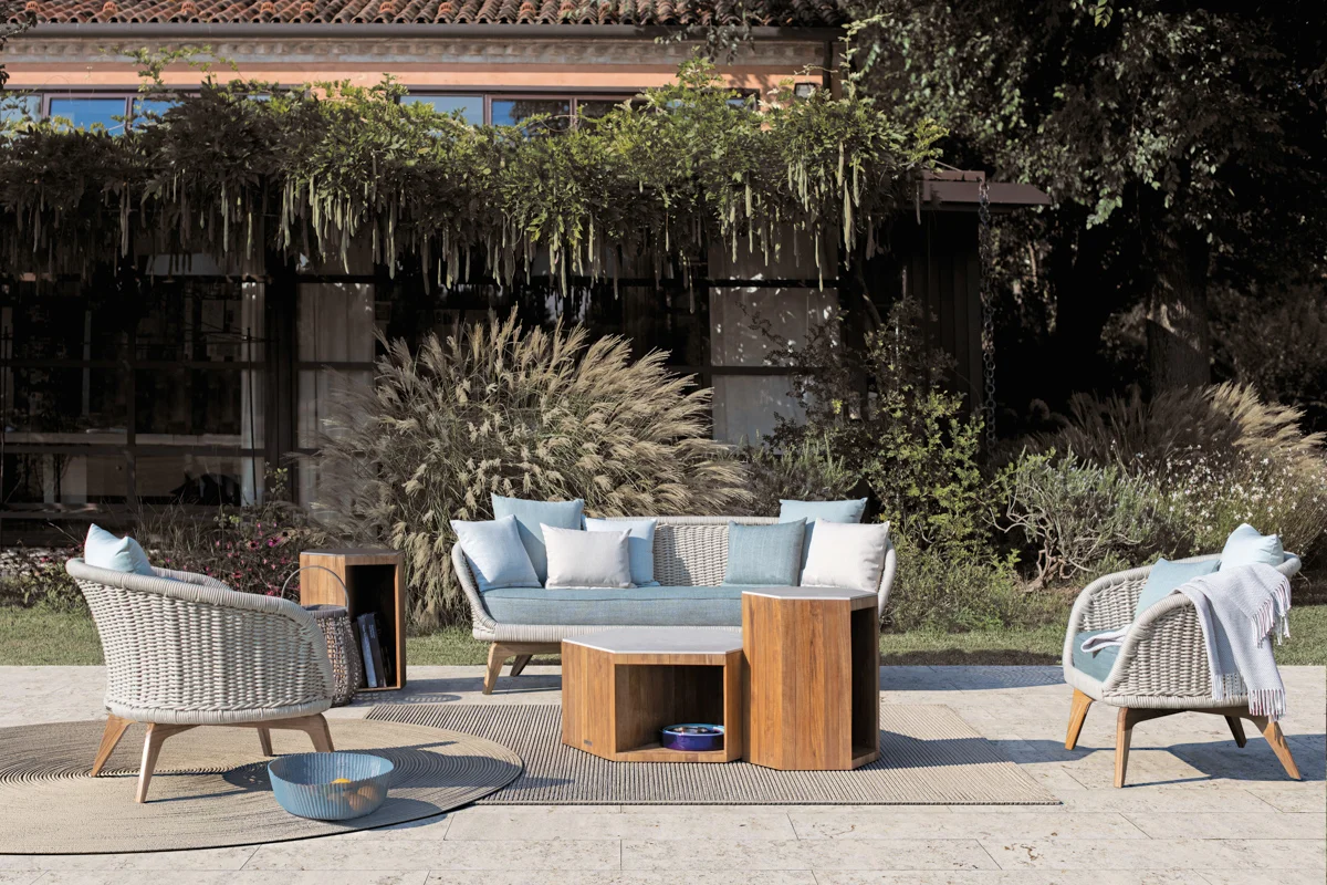 Outdoor throw draped over a chair, providing comfort for cooler summer evenings.