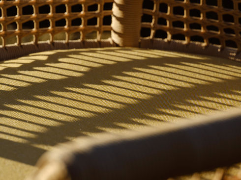 Close-up of the ESCALA Rocking Chair seat and woven backrest