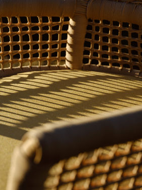 Close-up of the ESCALA Rocking Chair seat and woven backrest