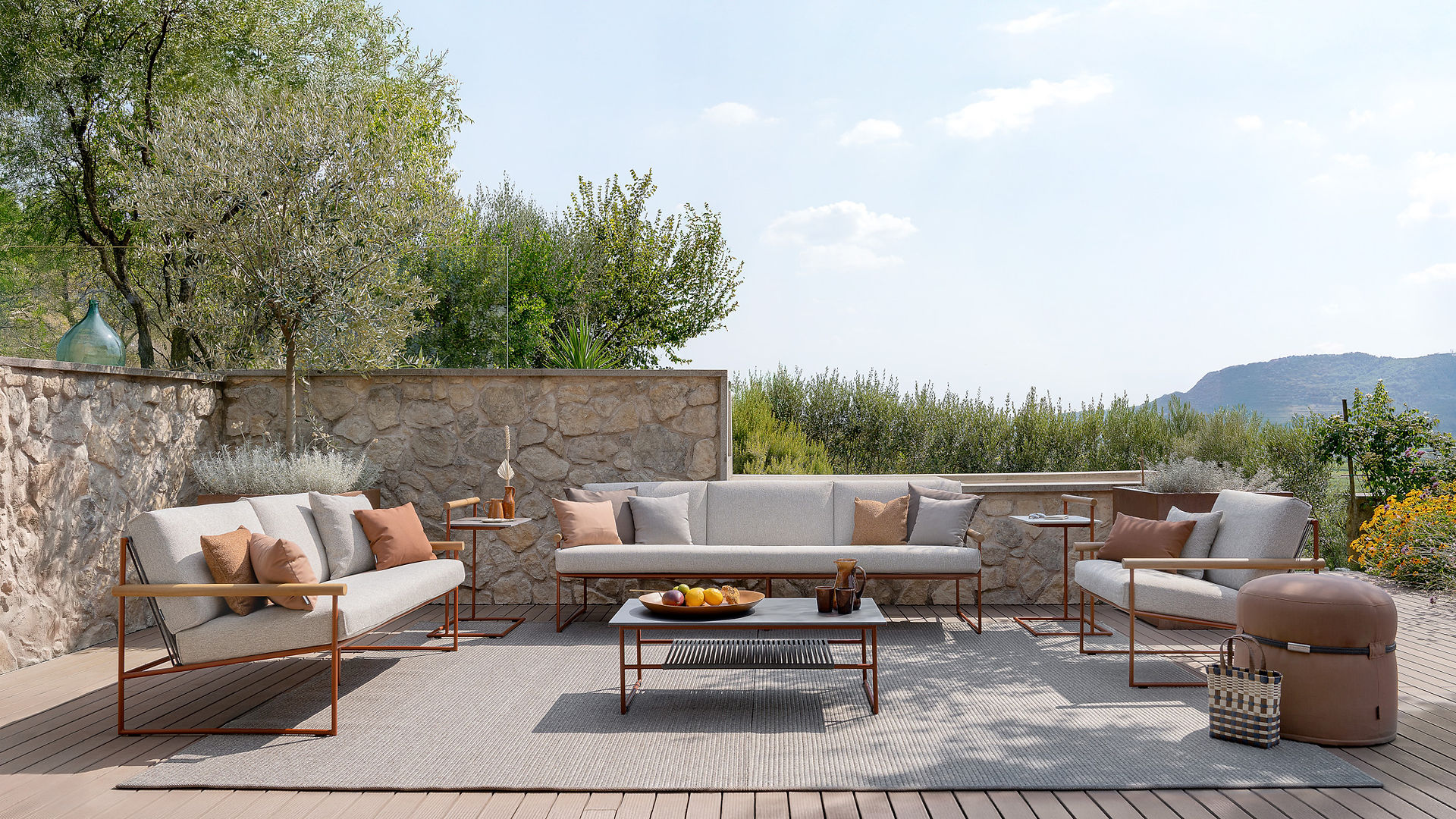 Contemporary outdoor lounge setting with Atmosphera Pipe sofas and coffee table in a calm architectural landscape