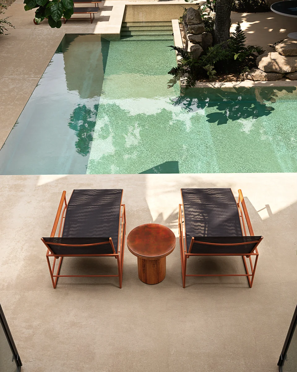 Pair of Atmosphera Pipe sun loungers with a round side table beside the pool