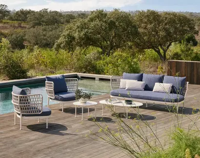 CURIO Sofa in an outdoor lounge, surrounded by natural landscaping.