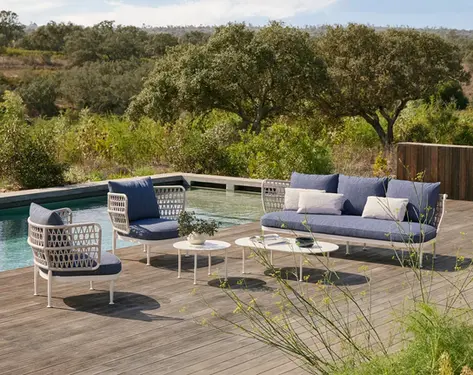 CURIO Sofa in an outdoor lounge, surrounded by natural landscaping.