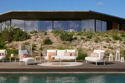 CURIO Sofa in an outdoor lounge, surrounded by natural landscaping.