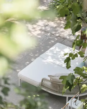 DREAM outdoor daybed pair with rope‑woven backrests, powder‑coated aluminium frames, and deep cushioned seating.