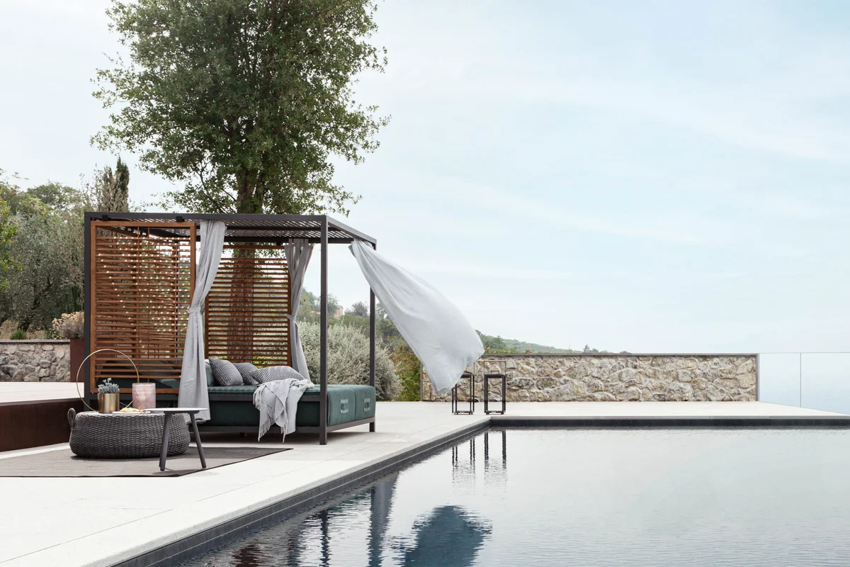 Alcova Collection daybed, offering shaded protection in an elegant outdoor design.