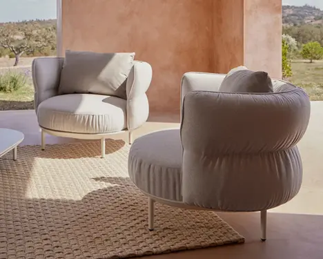 Amba Armchair with upholstered backrest.