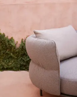 Amba Armchair with upholstered backrest.